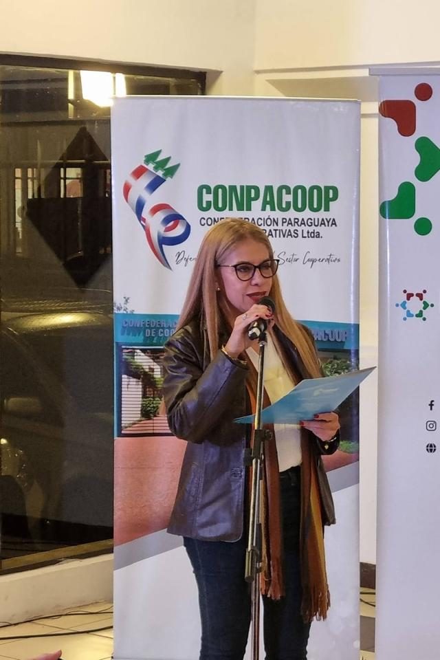 Cynthia Noguera conduciendo con micrófono en un evento de CONPACOOP